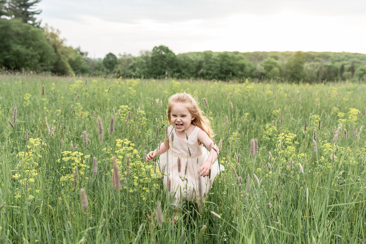 Little girl in pink dress running through field at Topsmead |Sharon Leger Photography | Canton, CT Newborn & Family Photographer