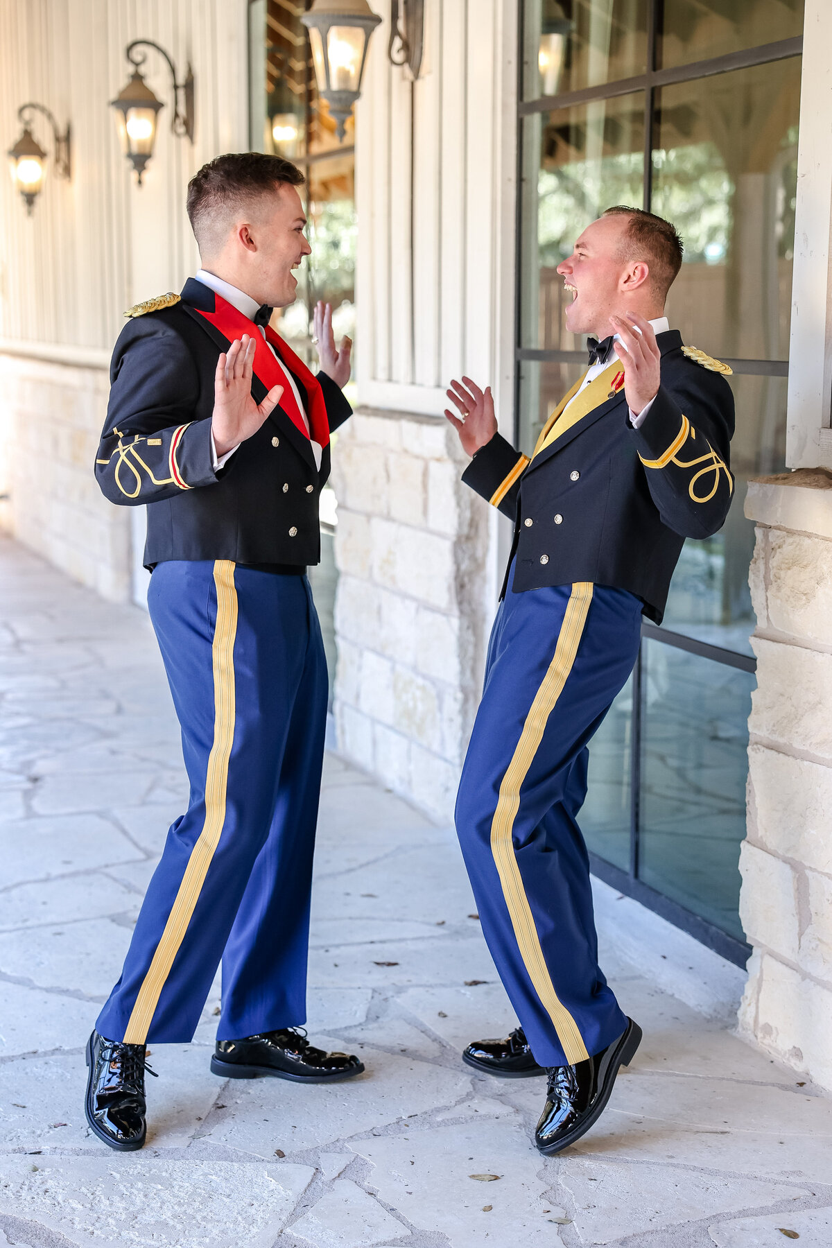groom and groomsman laugh and dance in uniform before wedding in Georgetown Texas