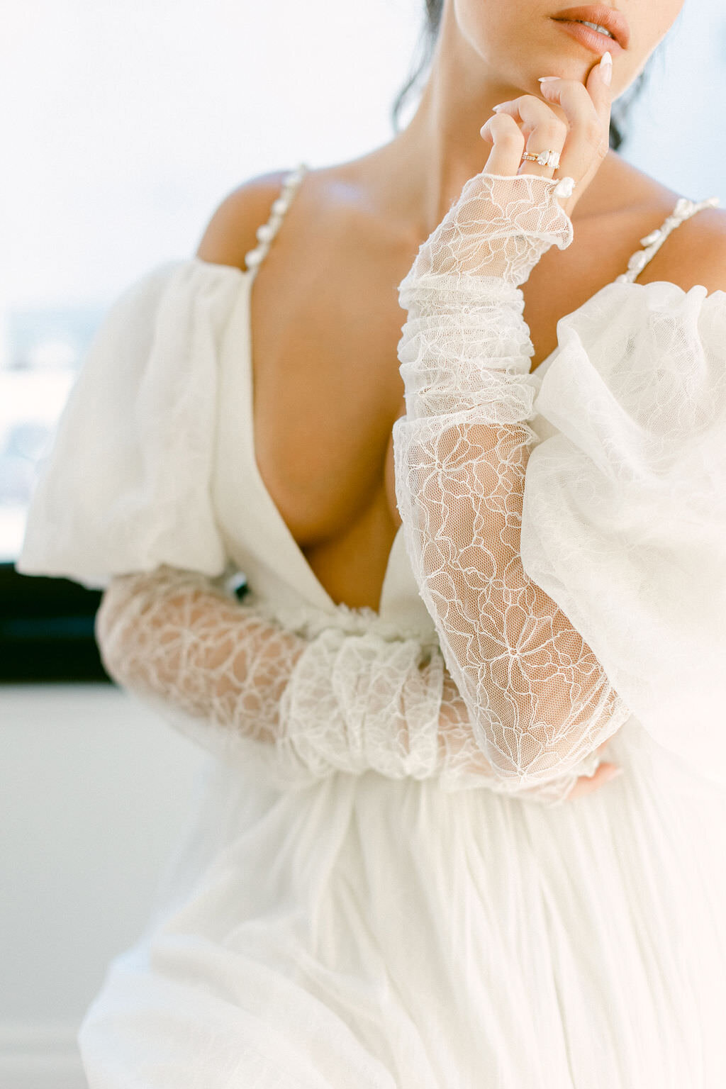 Close up of lace sleeves and puffed shoulders on modern sophisticated wedding gown