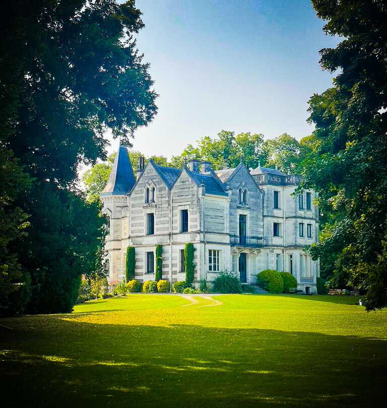 Elegant 19th-century French chateau surrounded by gardens and rolling countryside, home to intimate creative and painting retreats blending art, culture, and wellness.