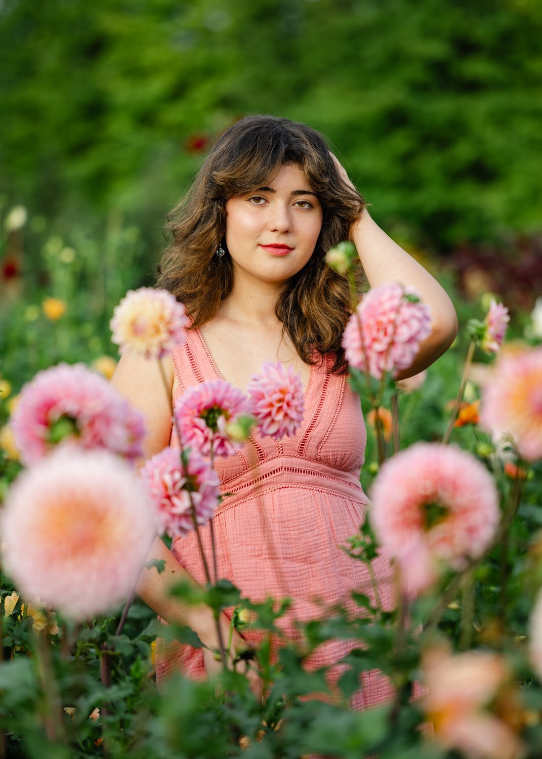 eastside catholic girl at dahlia flower garden in pink dress