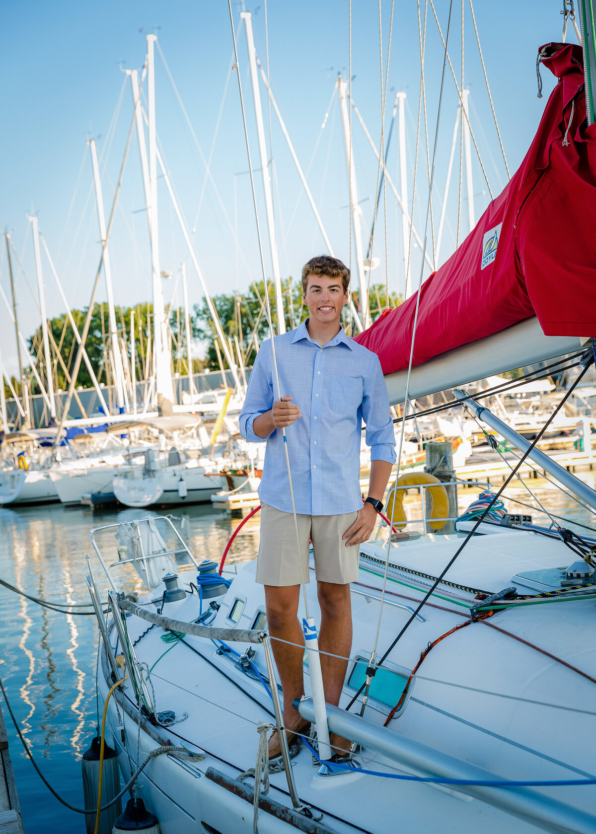 boy having his senior pictures taken at Rochester Boat and Yacht Club 