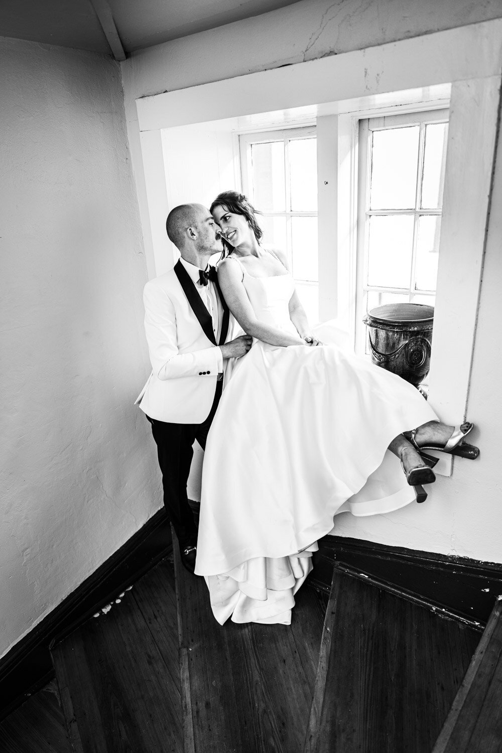 Bride and groom by window ledge in Latrobe's