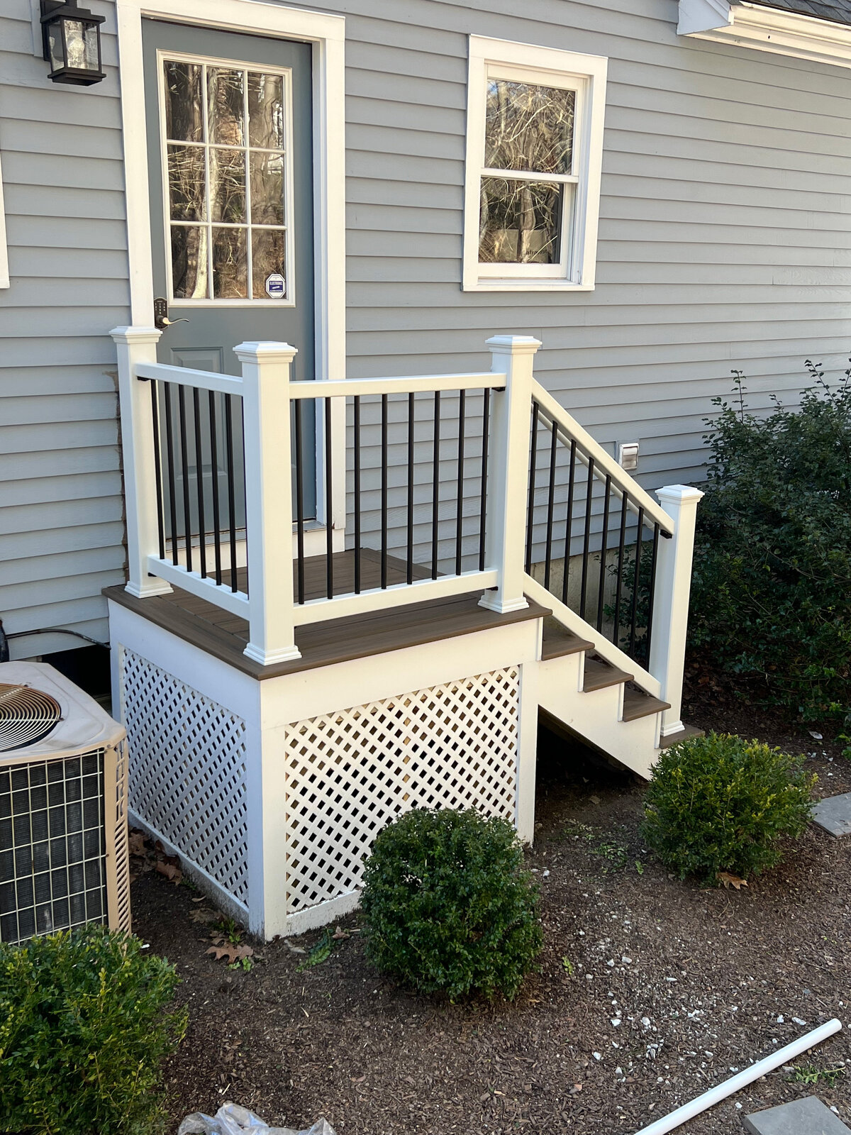 A view of a small set of stairs with white trellis facing Northborough Deck Contractor