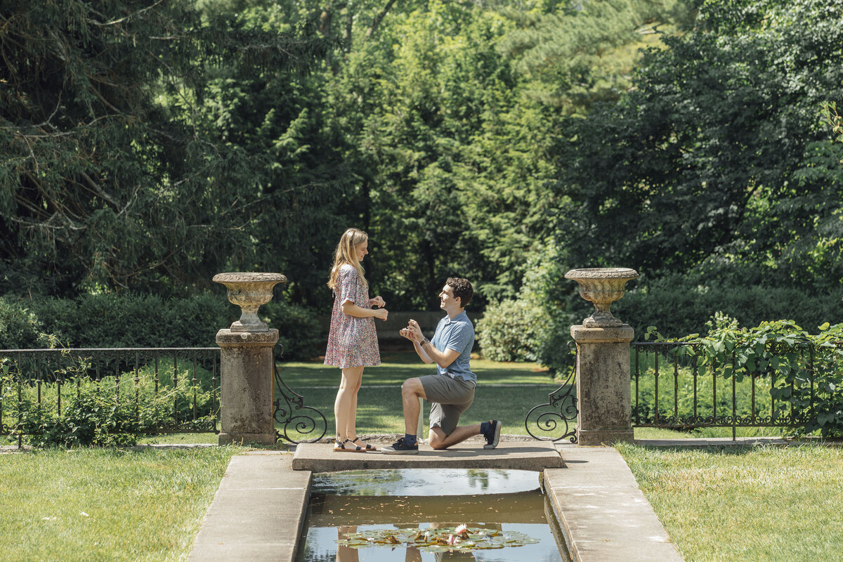 Proposal Photography | Groom-to-be proposing in the summer gardens surrounded by flowers and greenery | Ringwood, New Jersey
