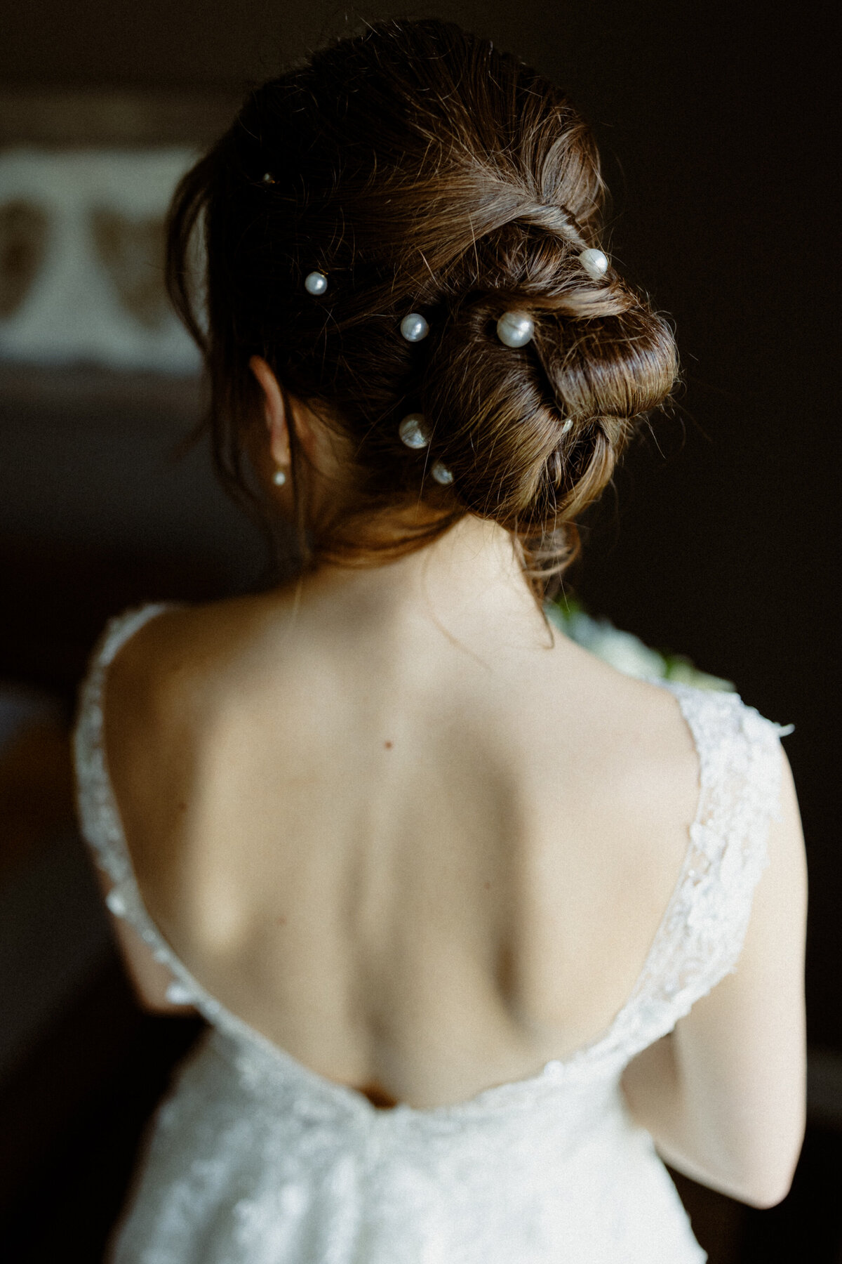 view-of-the-back-of-a-bridal-hairdo-with-contrasting-light-and-dark-background-1