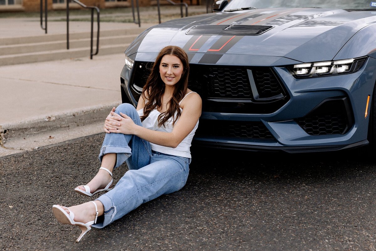Senior girl in denim and white, wearing white stiletto heels.