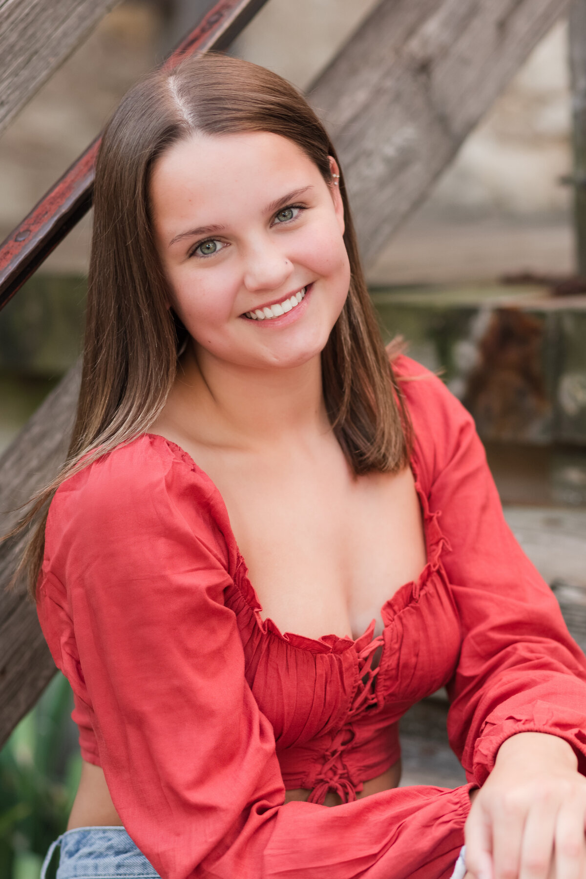 Senior girl seated on stairs and smiling at the camera