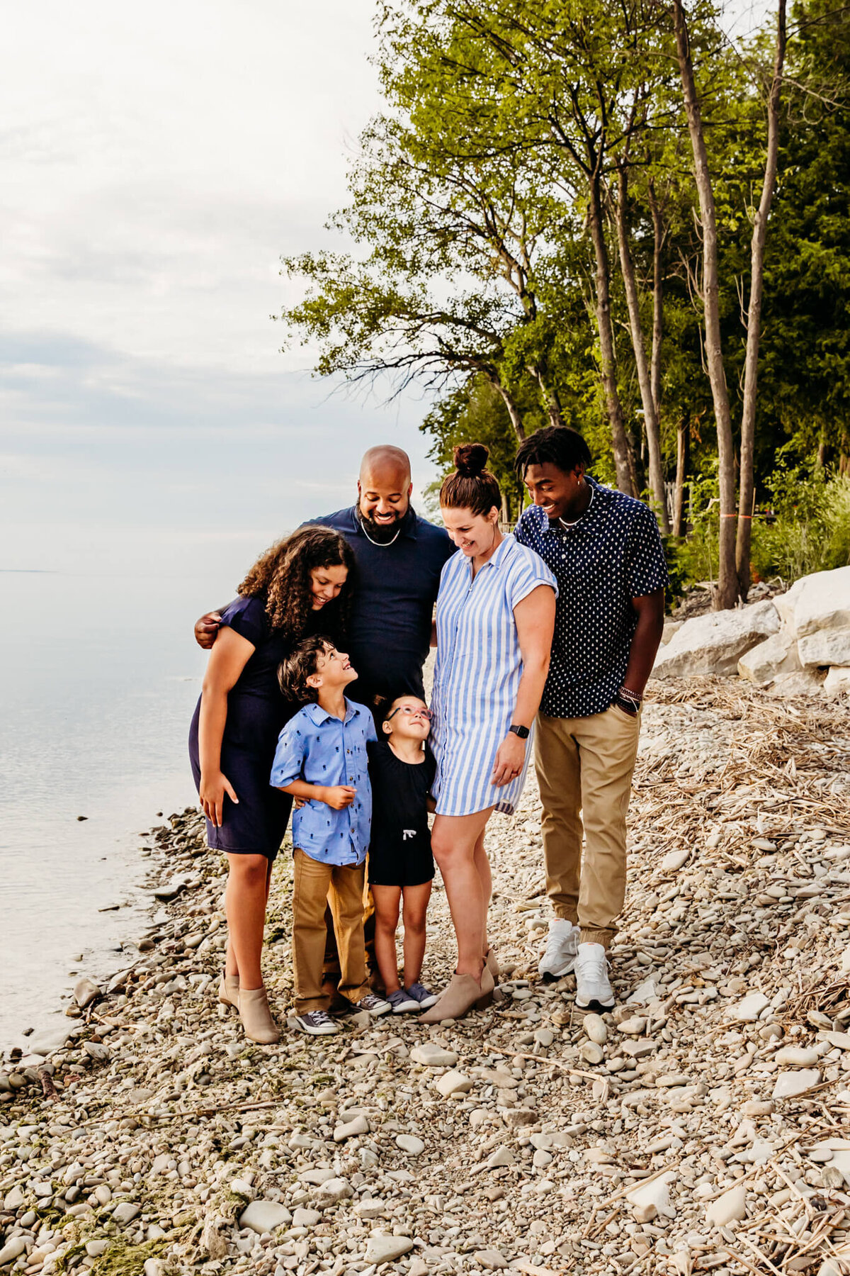 Mixed family snuggled on the beach in Door County. Captured by Ashley Kalbus Photography