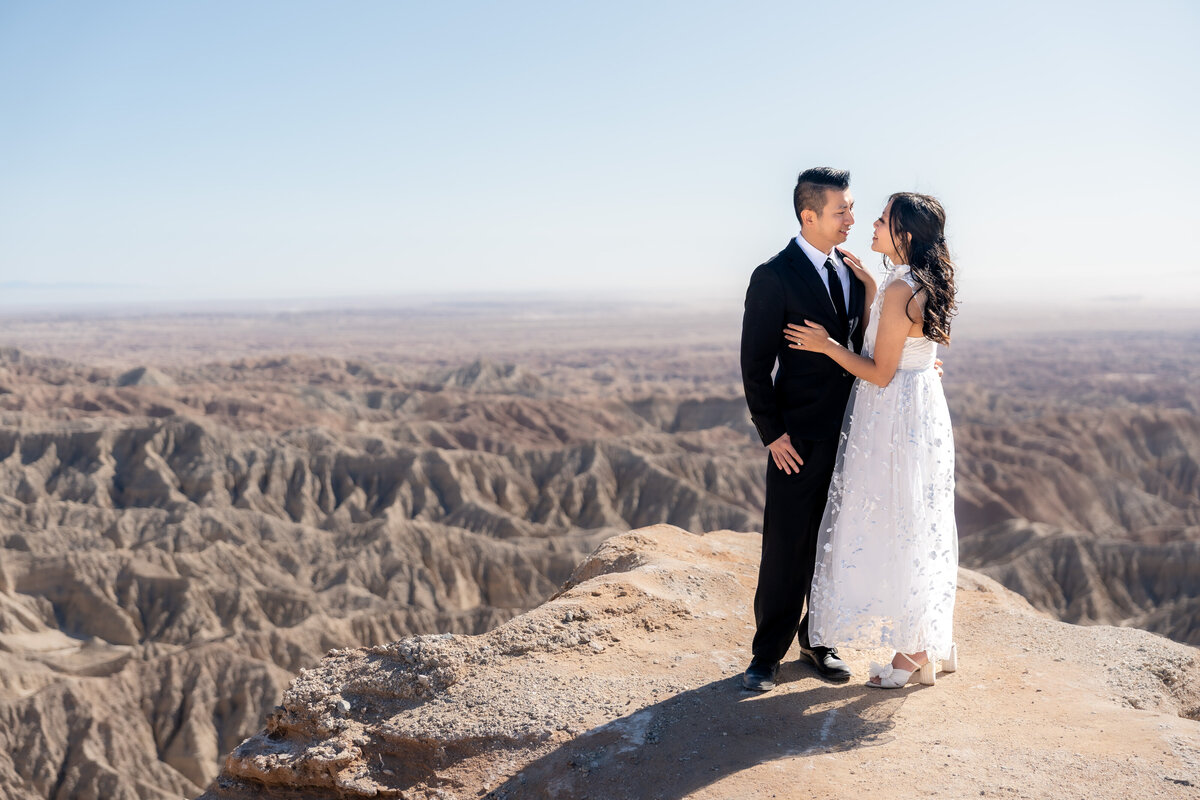 Anza Borrego elopement bride and groom at Fonts Point embracing.