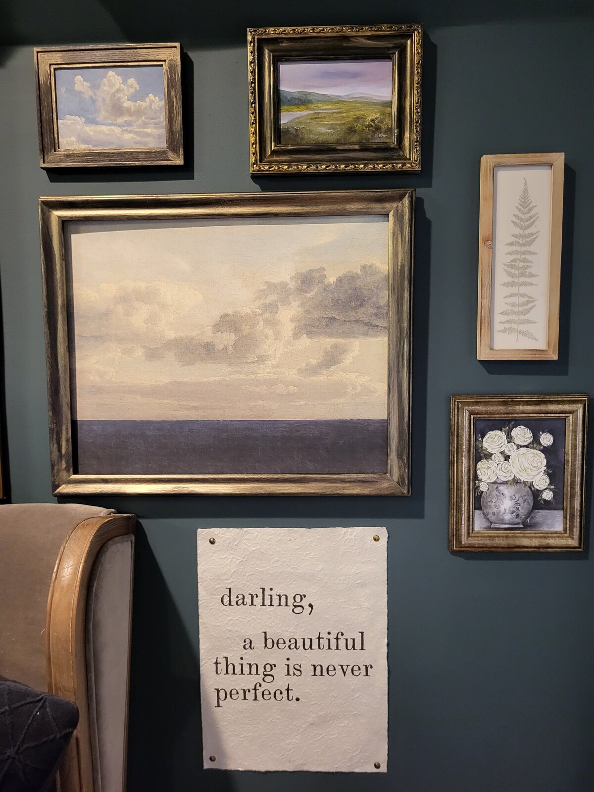 Gallery wall of artwork along with quote on handmade paper