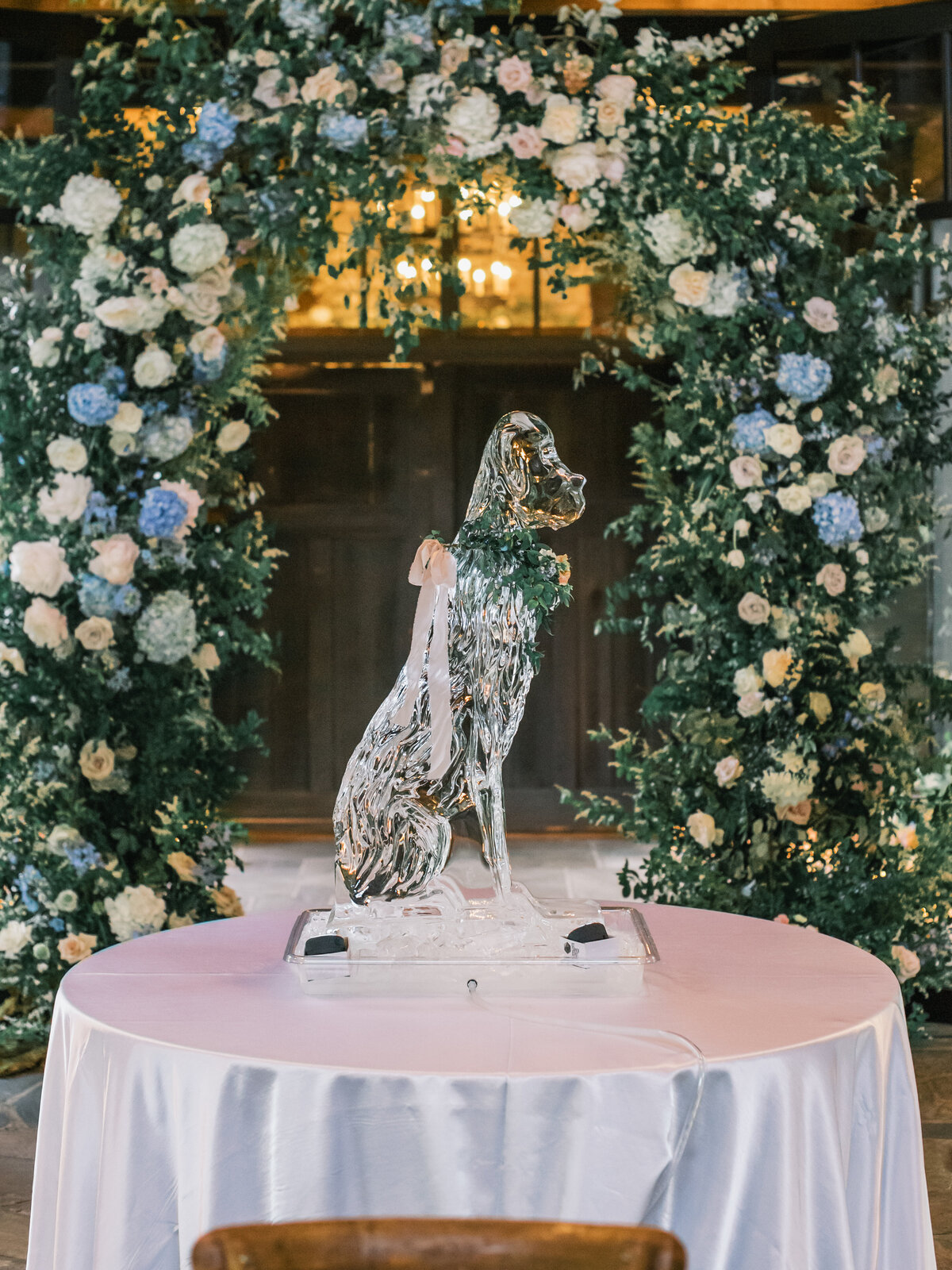 Custom dog-shaped ice sculpture with floral collar displayed at a wedding reception at Old Edwards Inn in Highlands, North Carolina.