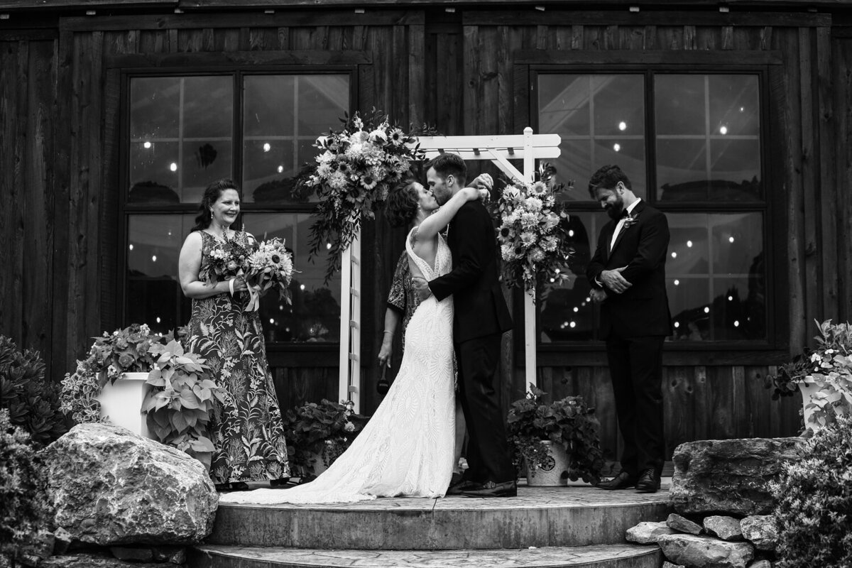 Bride and groom share first kiss at the end of their CHQ Barn wedding ceremony in Chautauqua, NY