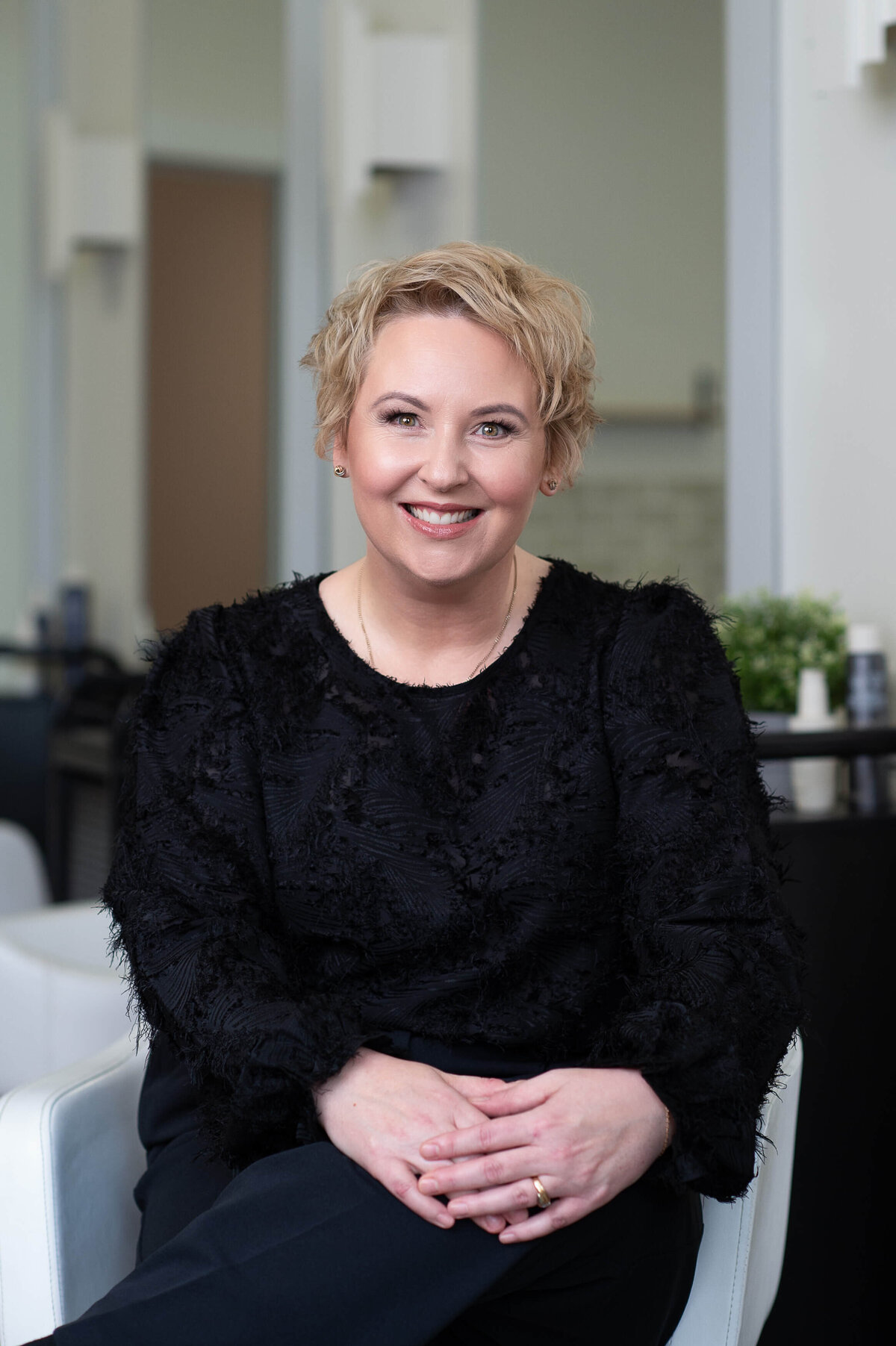 Ottawa brand photos of a stylist with short blonde hair and a black outfit at Richardson Hair Design.  Captured on location by JEMMAN Photography