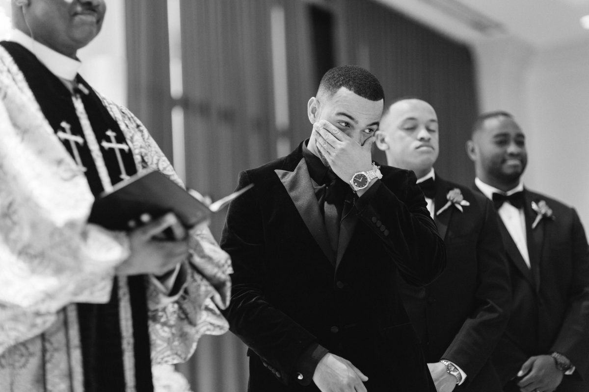 Groom crying at altar during ceremony