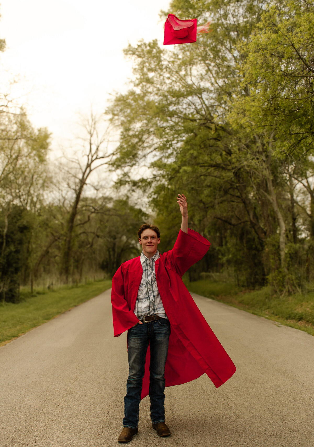 senior boy cap toss pose
