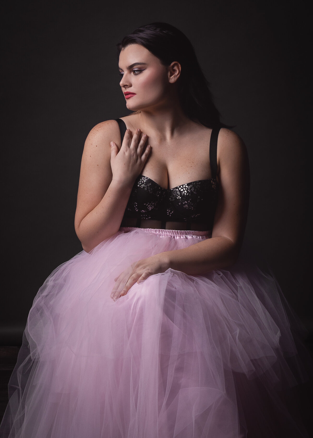 woman in pink flowing dress looking sideways