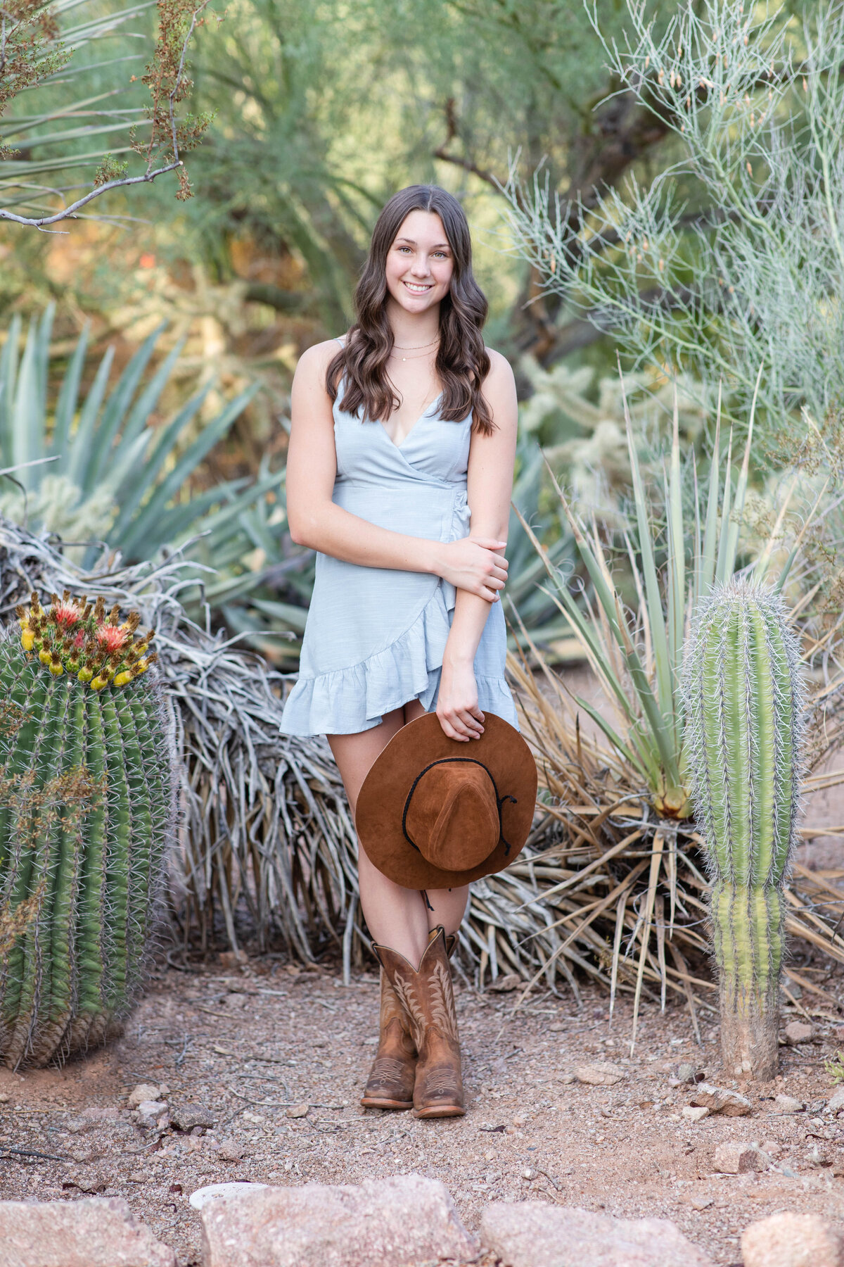 Senior girl satnding with hat with cactus Popago Park AZ