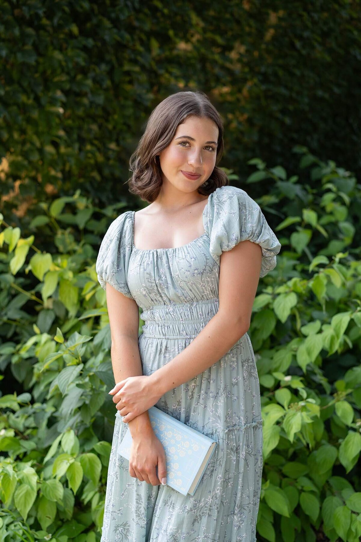 senior-girl-in-garden-with-book-prop
