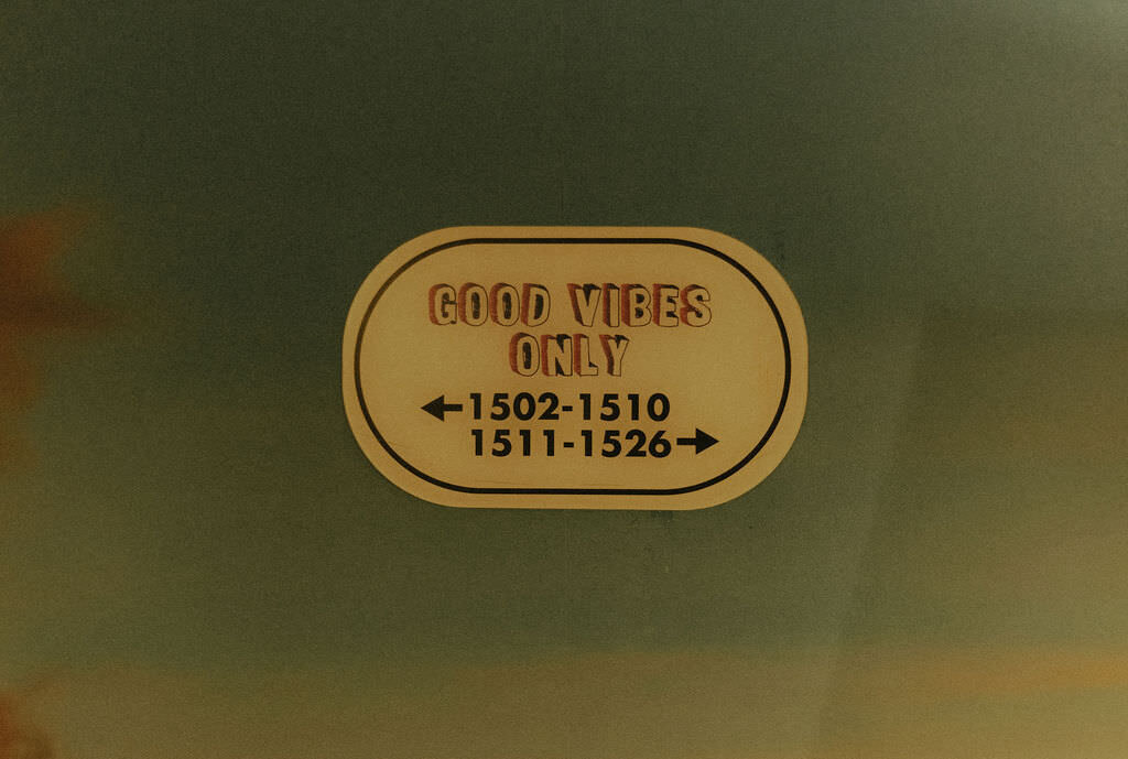 A sign for hotel rooms that reads "good vibes only.".