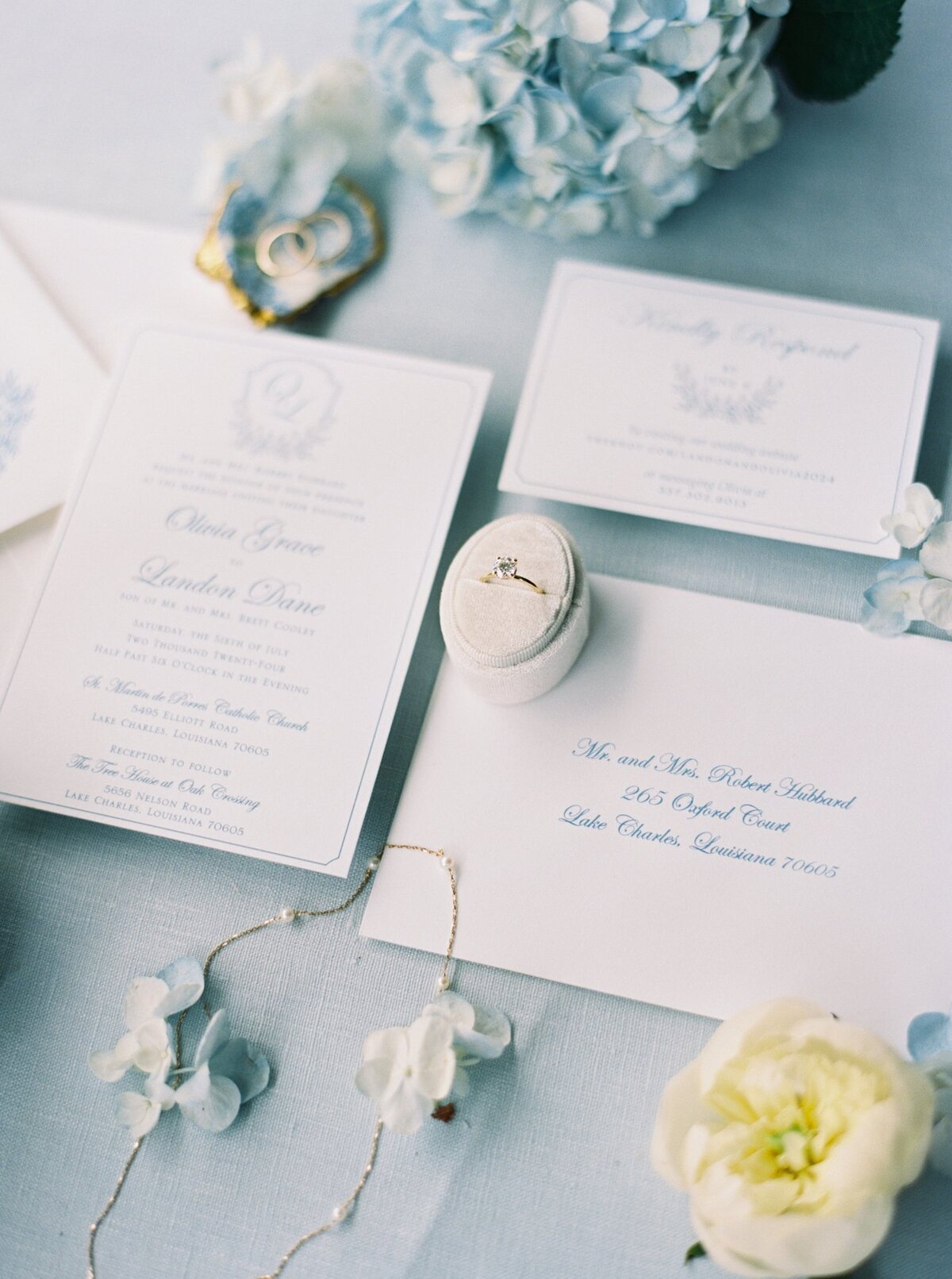 Elegant blue and white wedding invitation flat lay with coastal charm details, captured on film by Morgan Alysse, Louisiana film photographer.