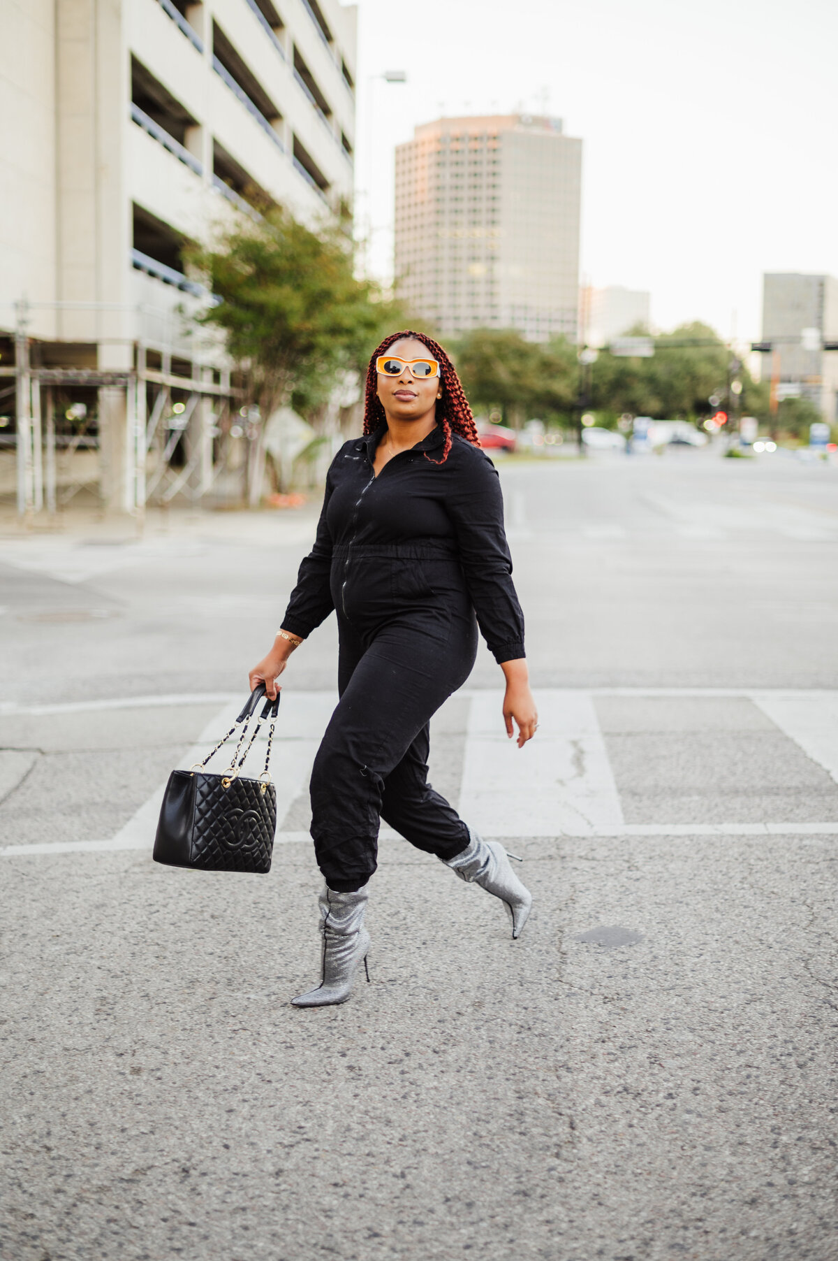 street photography influencer walking black jumpsuit silver boot heels