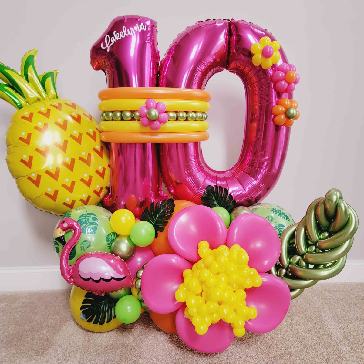 A girl's day extraordinary with Air with Flair Decor's Premium Balloon Bouquet featuring a delightful Pineapple and Pink Flower theme. The premium touch of our expertly crafted balloon artistry, creating a charming and memorable atmosphere.