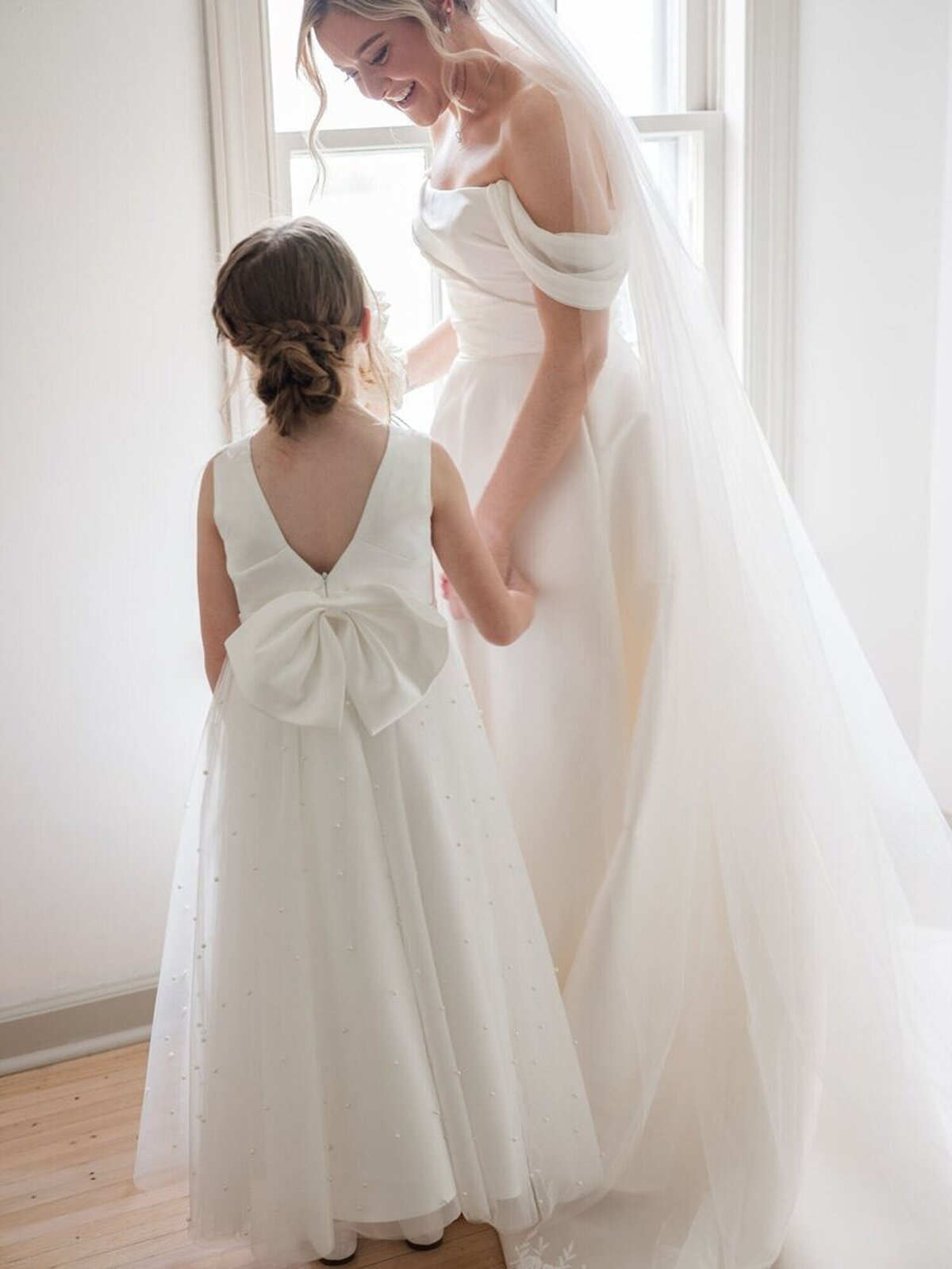 detroit michigan wedding photography of bride getting ready and holding hands with a little flower girl