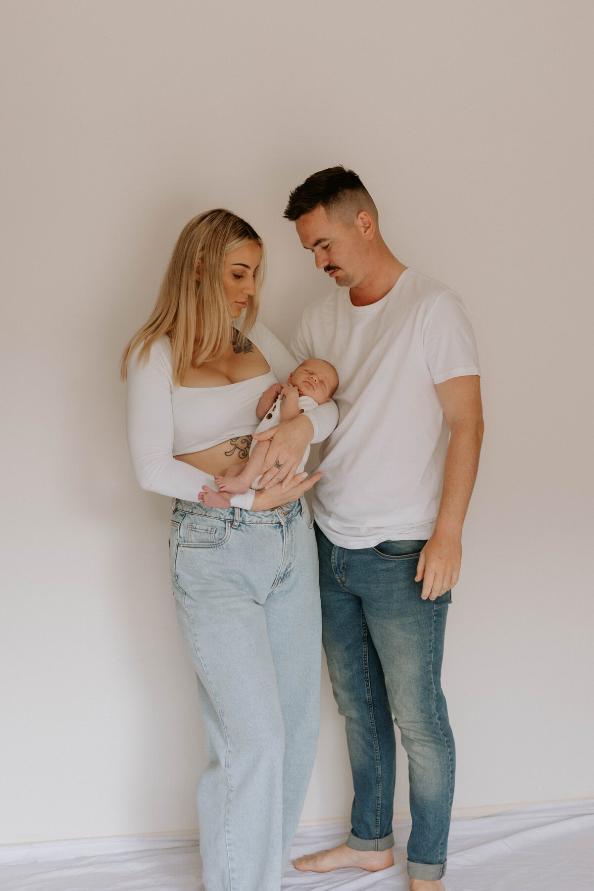 Mother and father looking at new baby