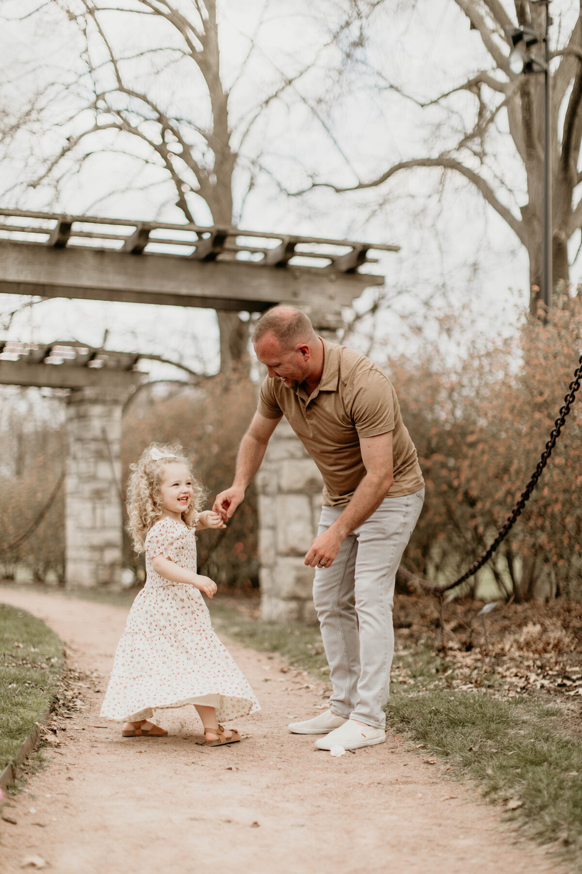 Dad spinning toddler in circles like a ballerina. 