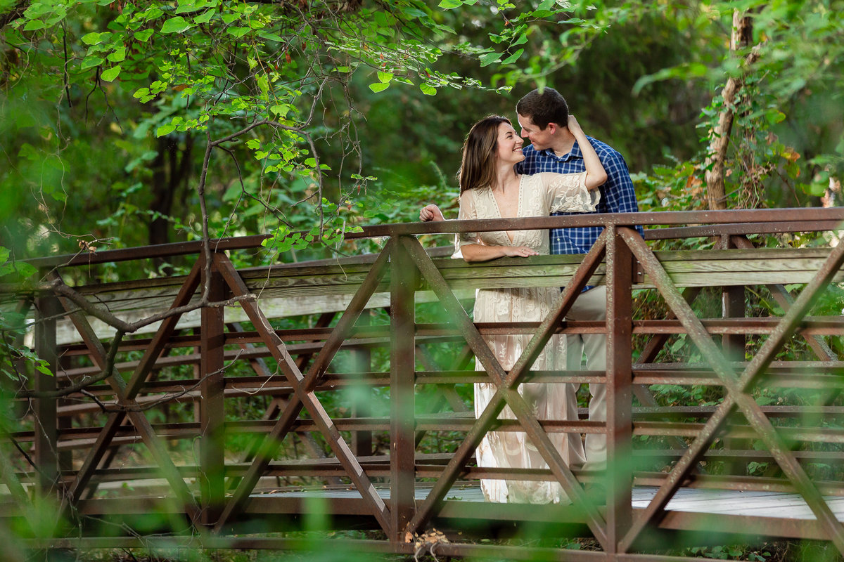 Couple embracing on magical bridge in park in colleyville nature center texas