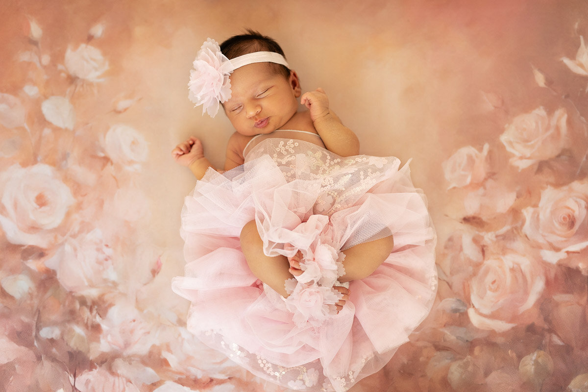 Baby girl in pink tutu dress during her newborn photo session in Calgary Alberta