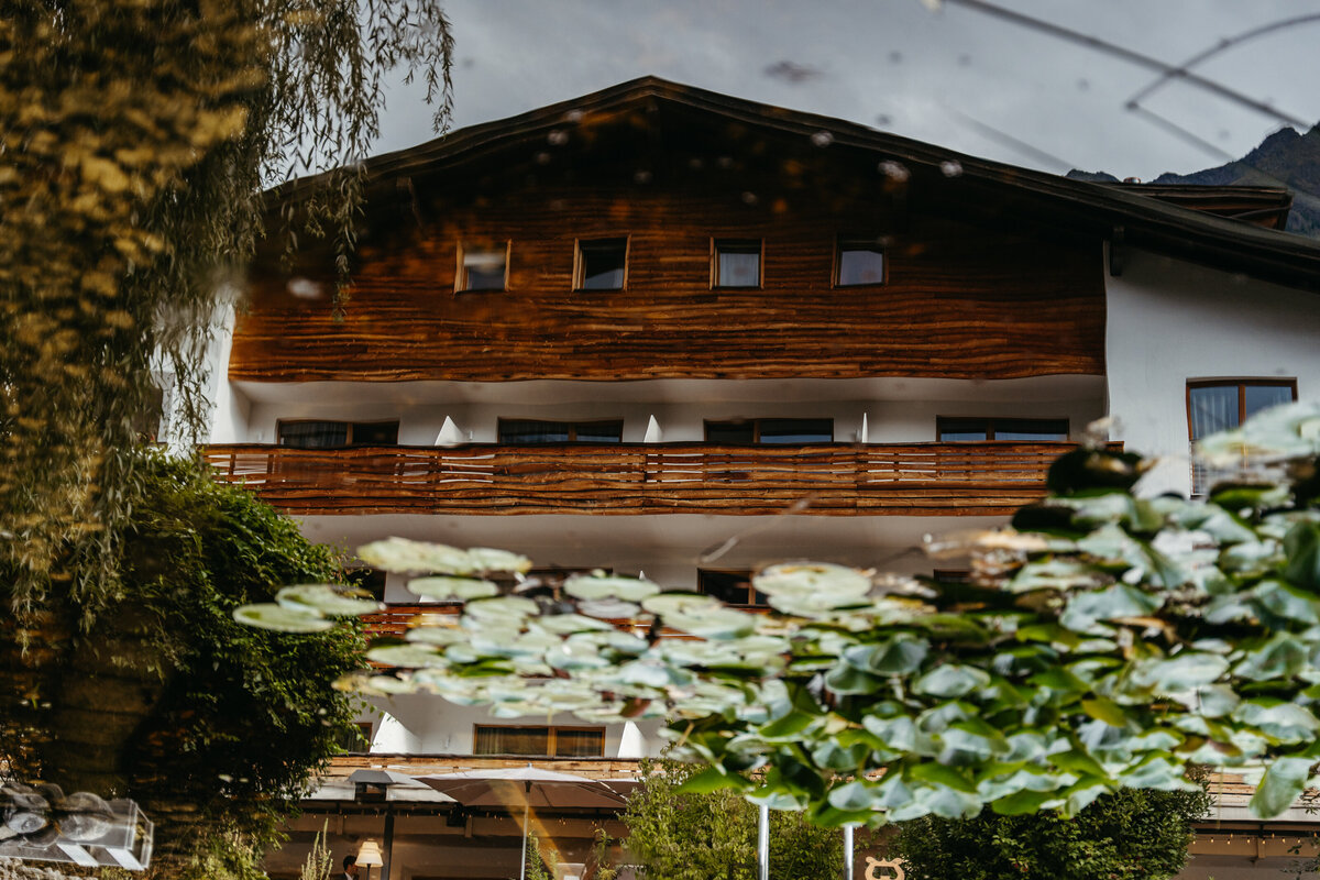 Wedding ceremony setup reflected in natural pond