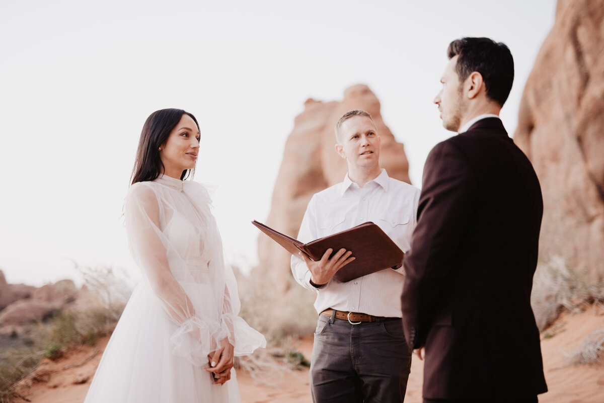Utah elopement photographer captures bride looking at groom during wedding ceremony