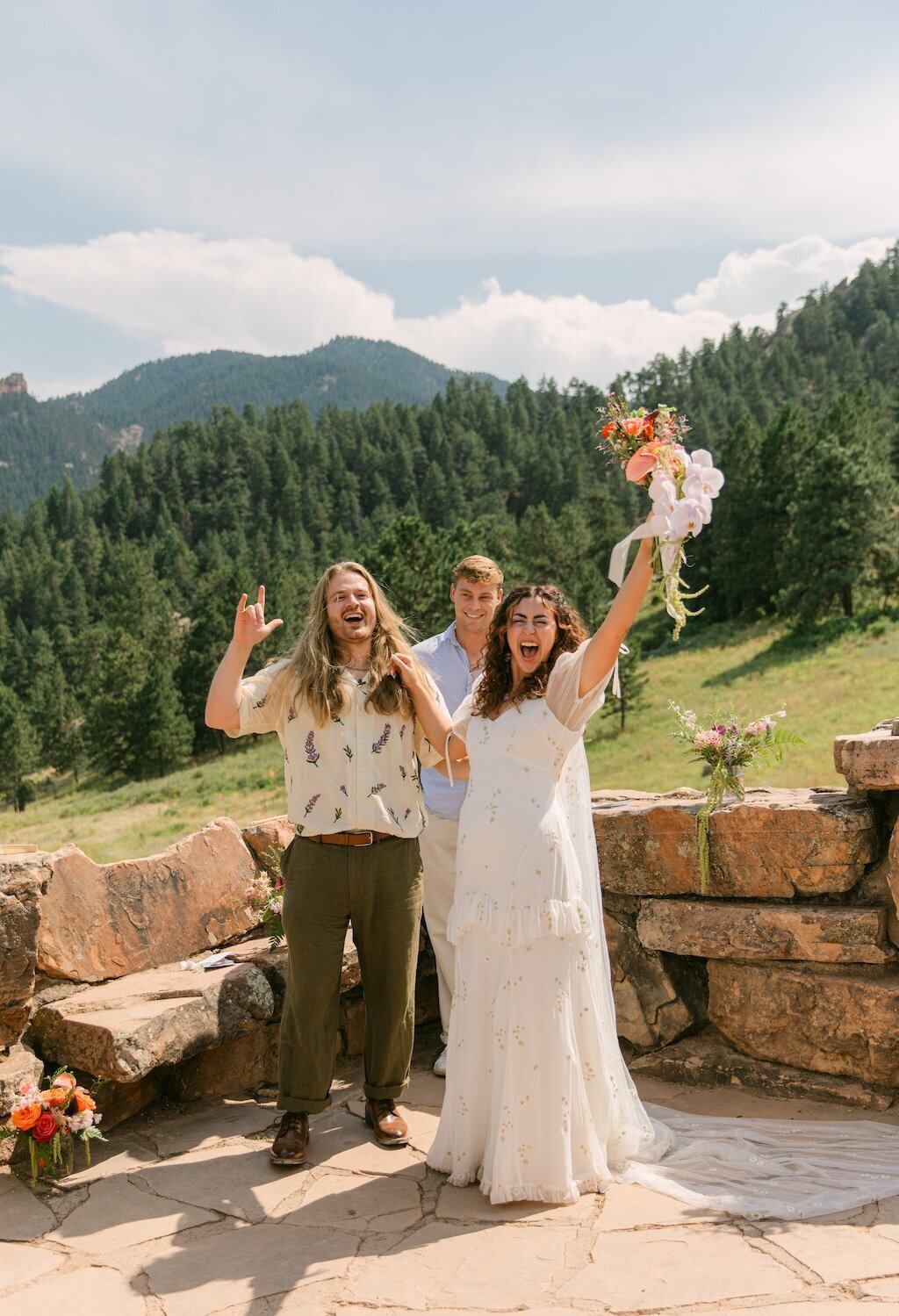 Very candid and joyful bride and groom at their outdoor mountain wedding ceremony in Boulder when they are announced as husband and wife.