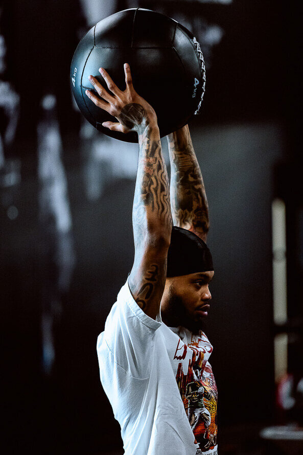 Denver Broncos player trains with a medicine ball at Kula Sports Performance in Denver.