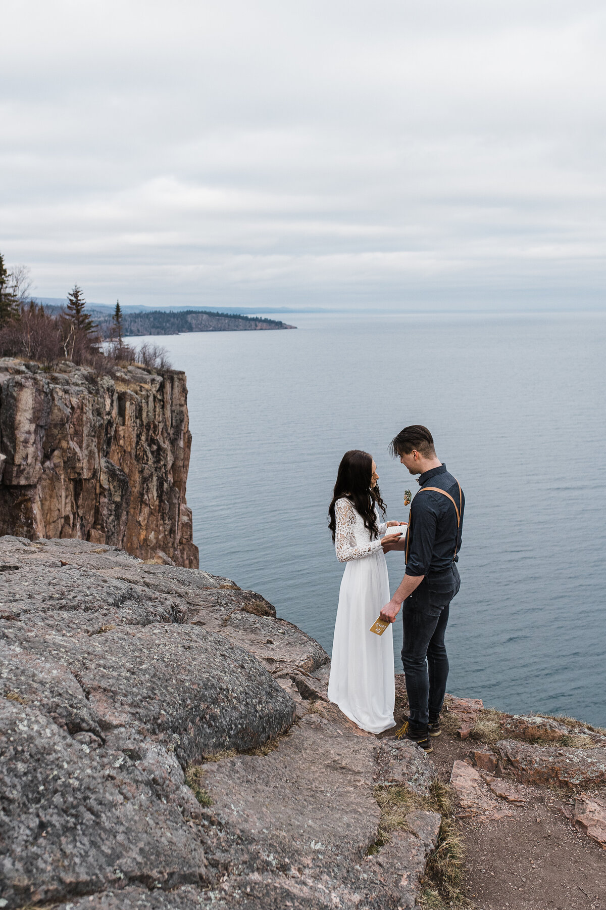 Couple reading vows over Lake Superior