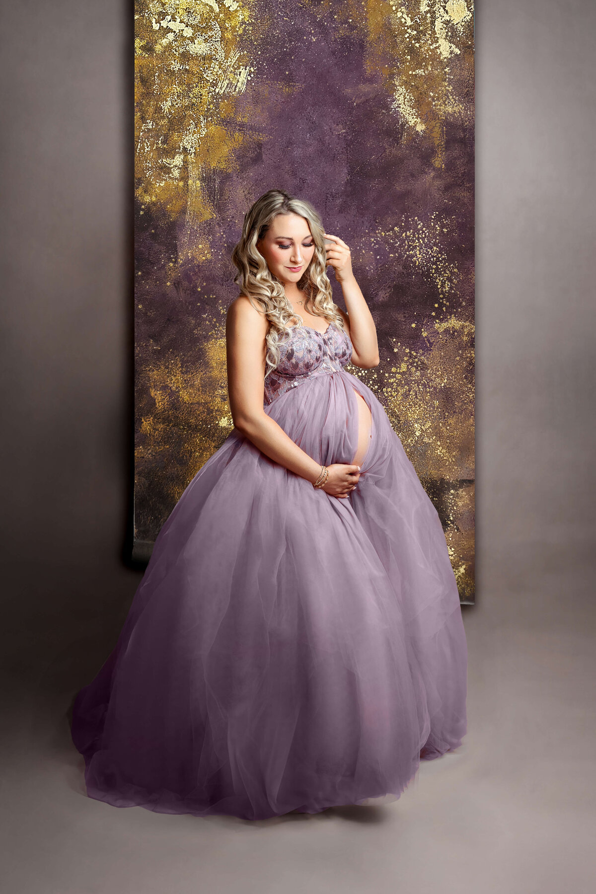 pregnant mother wearing a purple designer maternity gown at a maternity photo shoot in northern va