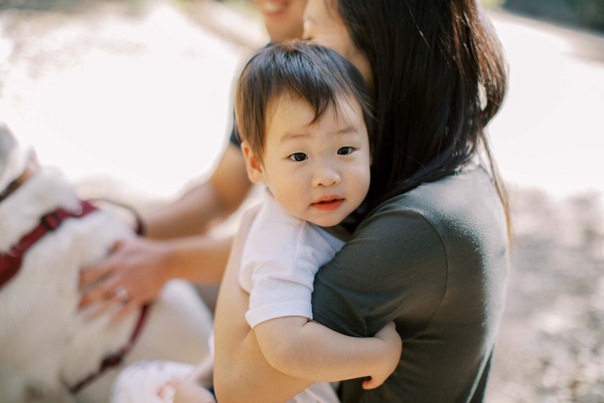 boy hugging mom and looking at camera