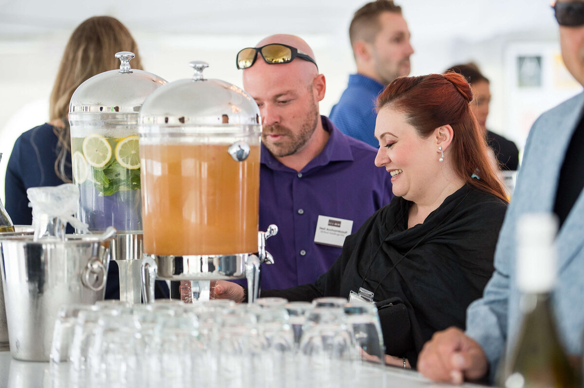 Ottawa event photos showing guests serving themselves at a water and juice station at a corporate anniversary celebration for Ell-Rod.  Captured by JEMMAN Photography COMMERCIAL