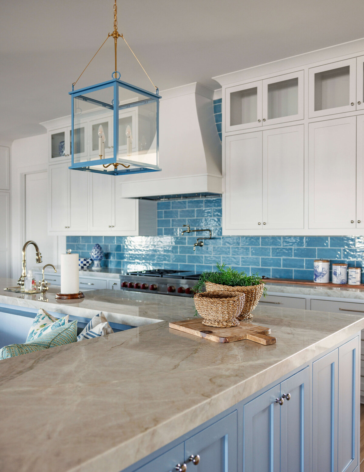 oyster creek studios lighthouse on the lake light blue cabinets on brown marble countertops and blue tile in kitchen