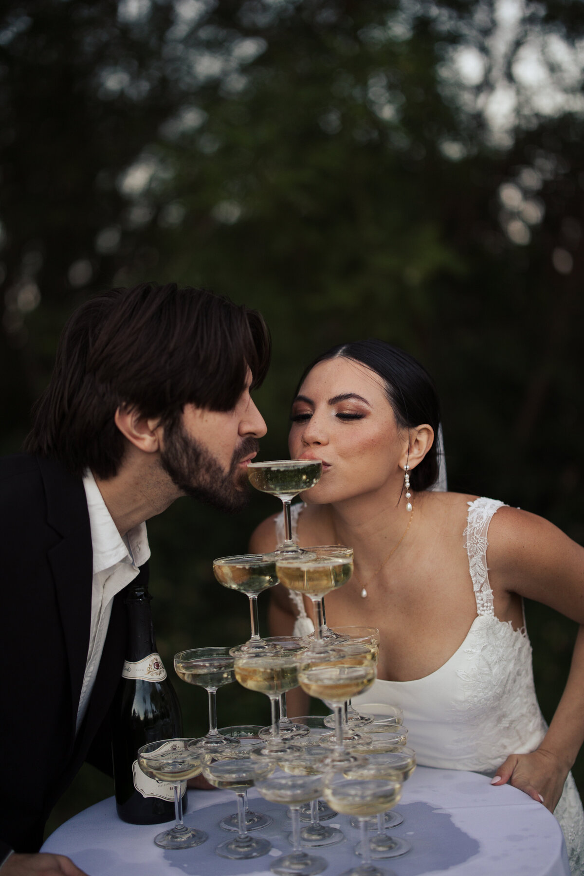 Bride and groom pouring champagne