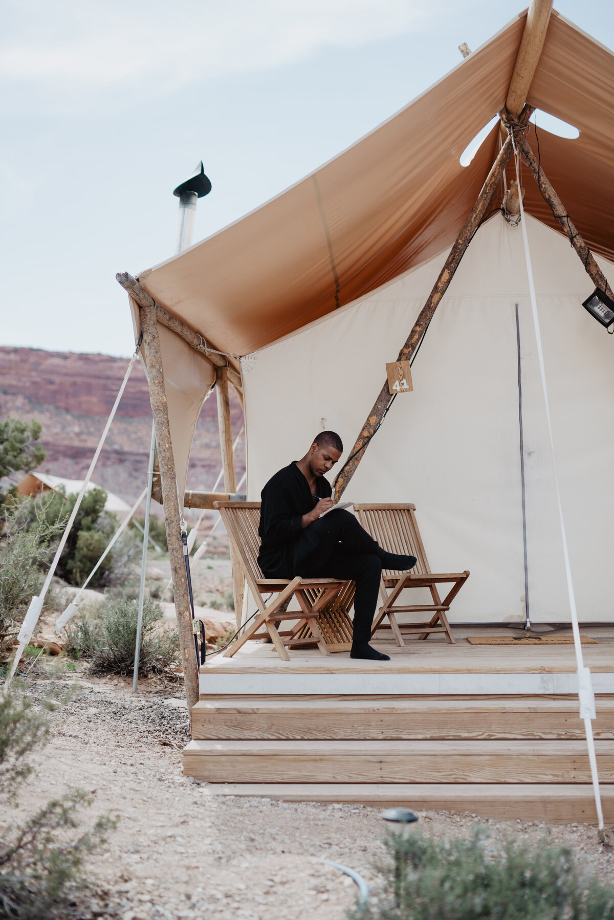 Utah Elopement Photographer captures man sitting on bench writing vows