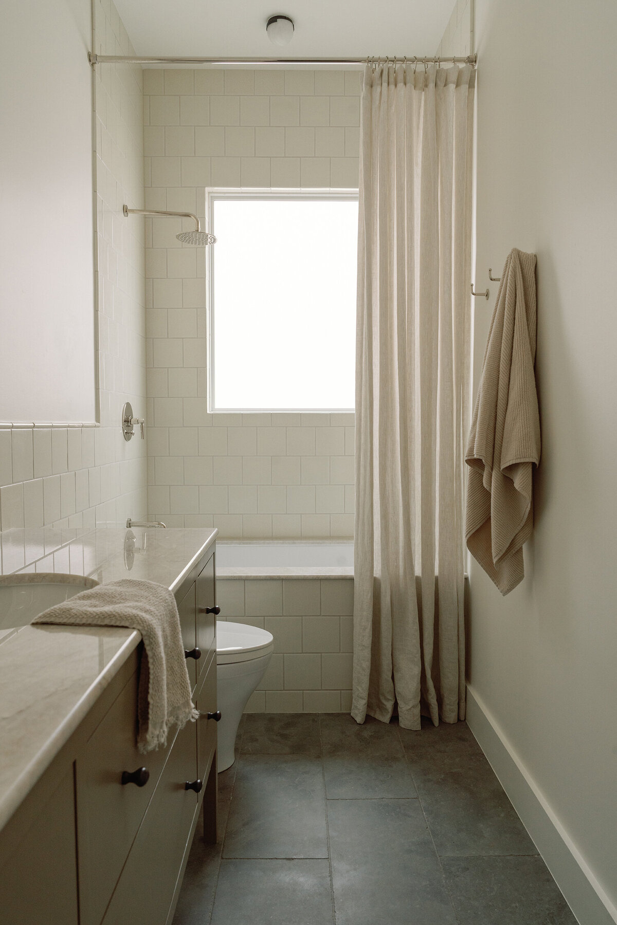 House-Franc-historical-bathroom-remodel-renovation-green-bronze-vanity-taj-mahal-quartzite-countertops-nickel-limestone-tile-crackle-tile-traditional-modern-bathroom-phylrich-bronze-knobs-warm-cozy-austin-texas