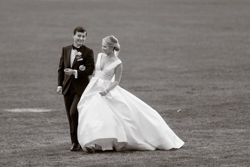 groom-bride-walking-field-photojournalism
