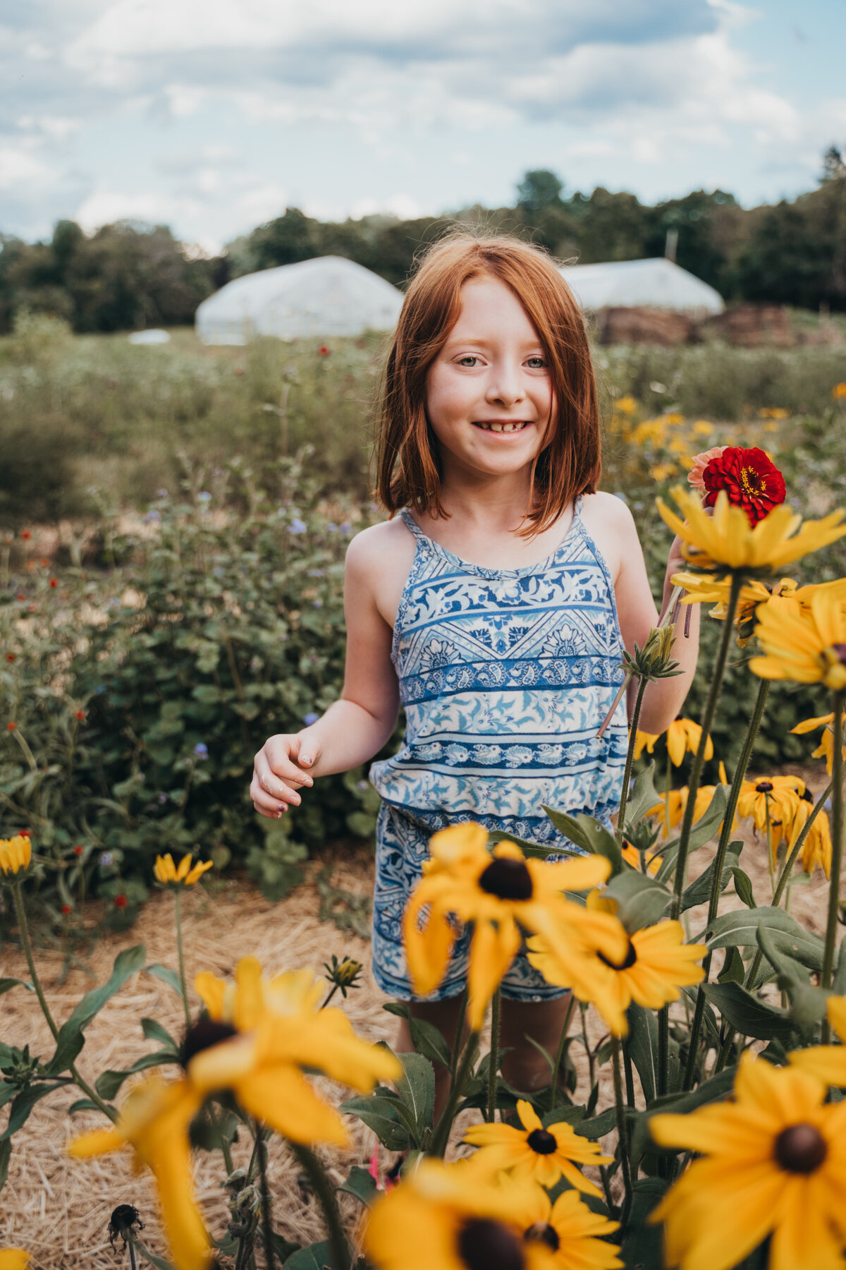 girl standing in wild flowers