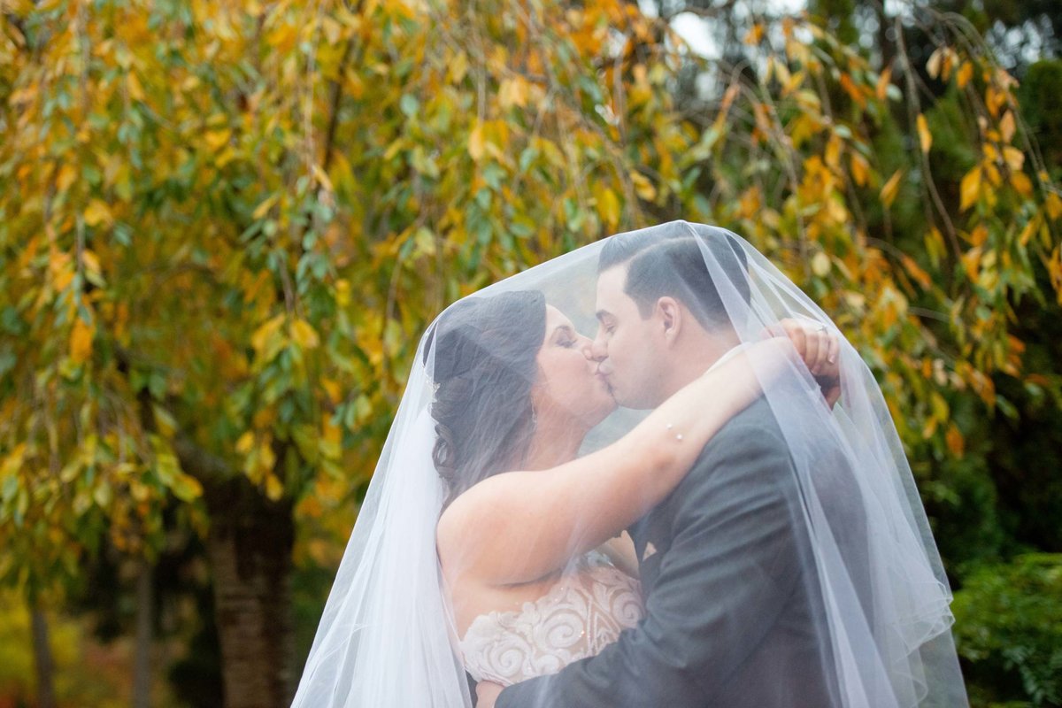 Bride and groom under the veil at Fox Hollow