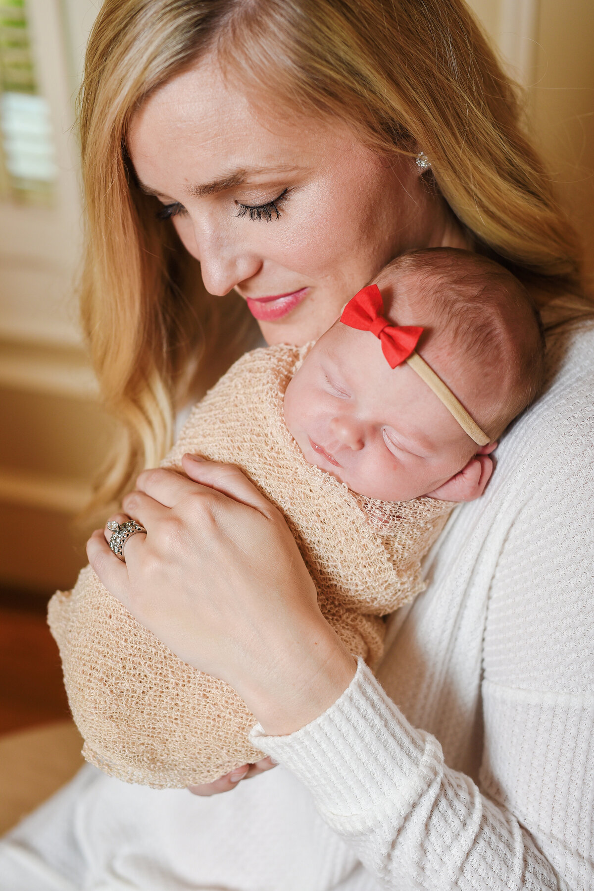 Beautiful Mississippi Newborn Photography: mom holds newborn baby girl