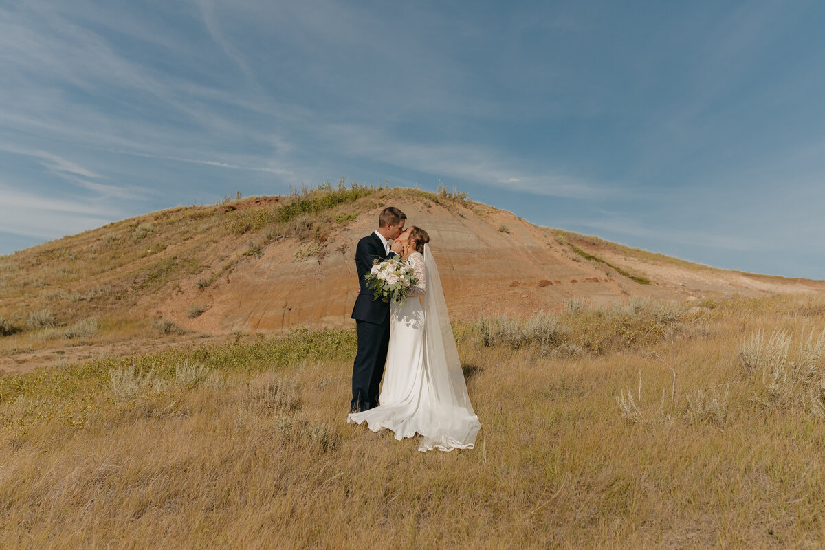 bride & groom in front of sand dune