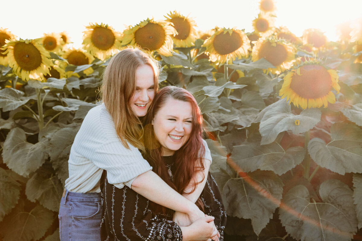 Couple hugging at sunset in sunflowers for couples photos